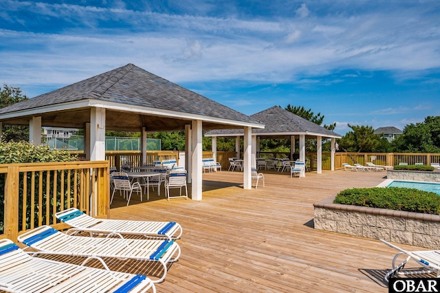 655 Pampas Ct Lot 162, Corolla, NC 27927 - deck featuring a gazebo, outdoor dining area, a fenced backyard, and a community pool