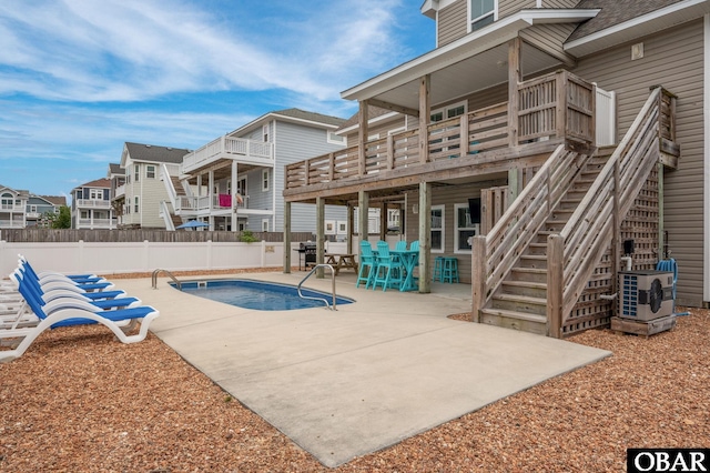 655 Pampas Ct Lot 162, Corolla, NC 27927 - community pool with a patio, a wooden deck, a residential view, and stairway