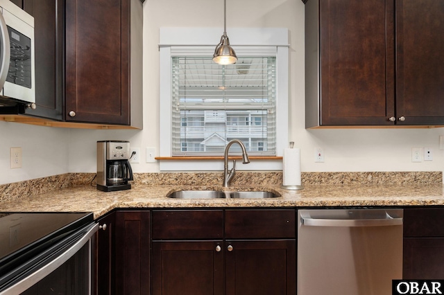 655 Pampas Ct Lot 162, Corolla, NC 27927 - kitchen with dishwasher, dark brown cabinetry, range with electric stovetop, and decorative light fixtures