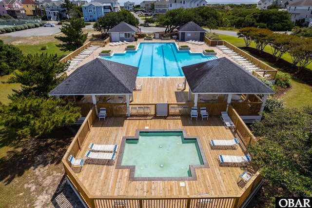 655 Pampas Ct Lot 162, Corolla, NC 27927 - community pool featuring a wooden deck, a gazebo, a residential view, and an outbuilding