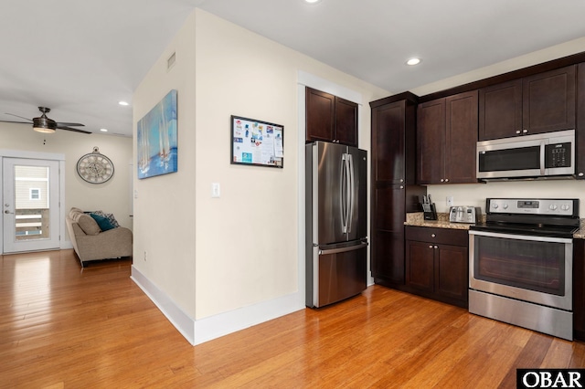 655 Pampas Ct Lot 162, Corolla, NC 27927 - kitchen with appliances with stainless steel finishes, dark brown cabinetry, light wood-style flooring, recessed lighting, and ceiling fan