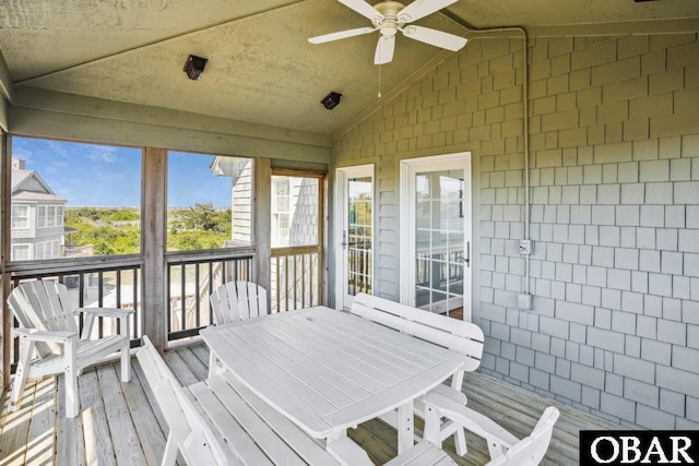 wooden deck with outdoor dining space and ceiling fan