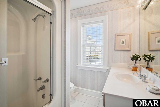 bathroom with shower / bath combination with glass door, wallpapered walls, toilet, vanity, and tile patterned floors