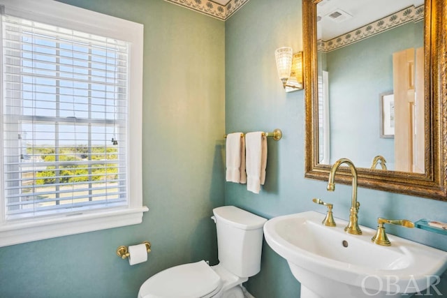 bathroom with visible vents, a sink, and toilet