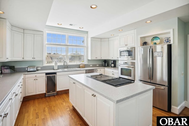 140 N Spinnaker Ct Lot # 20, Duck, NC 27949 - kitchen with appliances with stainless steel finishes, white cabinetry, a center island, and recessed lighting
