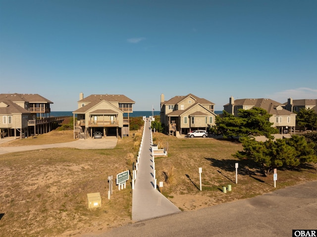 view of front of property with a residential view and a water view