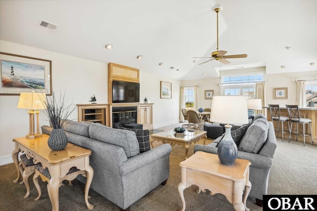 carpeted living area featuring a healthy amount of sunlight, visible vents, vaulted ceiling, and recessed lighting