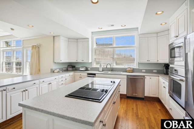 kitchen with appliances with stainless steel finishes, white cabinets, and light countertops