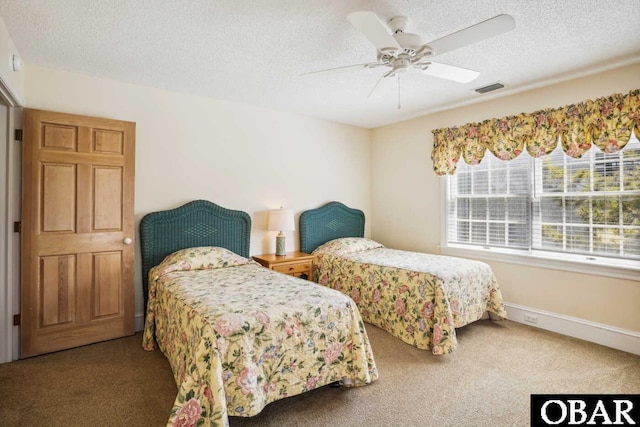 carpeted bedroom featuring a ceiling fan, visible vents, a textured ceiling, and baseboards