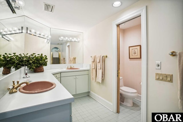 full bathroom with double vanity, visible vents, toilet, tile patterned floors, and a sink