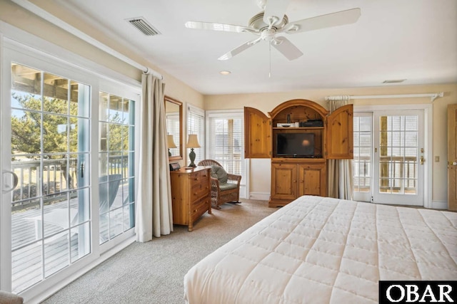 bedroom featuring light carpet, access to outside, visible vents, and ceiling fan