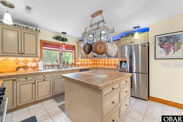 294 Hillcrest Dr Lot 20, Southern Shores, NC 27949 - kitchen with stainless steel fridge, cream cabinetry, and light tile patterned flooring