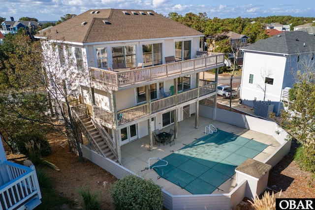 841 Golden Bluff Way Lot 336, Corolla, NC 27927 - back of property featuring stairs, roof with shingles, a patio area, a balcony, and a covered pool