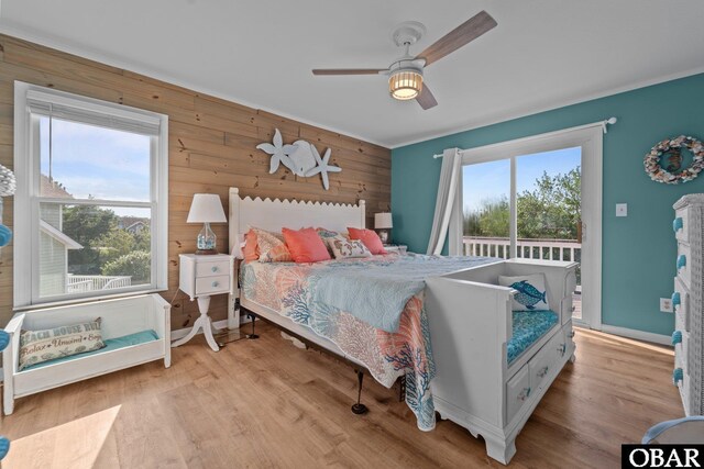 4121 W Whispering Winds Ct Lot 17, Nags Head, NC 27959 - bedroom featuring wooden walls, light wood-style flooring, access to exterior, and ceiling fan