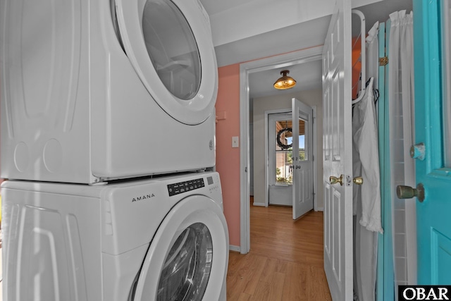 4121 W Whispering Winds Ct Lot 17, Nags Head, NC 27959 - washroom with estacked washer and dryer, light wood-style flooring, and baseboards