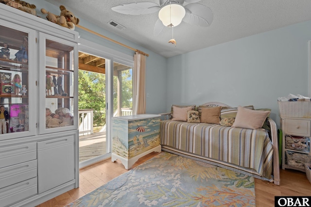 4121 W Whispering Winds Ct Lot 17, Nags Head, NC 27959 - bedroom with access to outside, light wood-style flooring, a textured ceiling, and ceiling fan