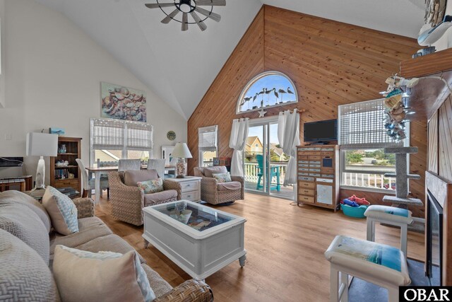 4121 W Whispering Winds Ct Lot 17, Nags Head, NC 27959 - living area featuring high vaulted ceiling, wooden walls, a ceiling fan, and wood finished floors