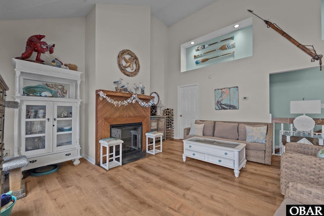 4121 W Whispering Winds Ct Lot 17, Nags Head, NC 27959 - living area featuring a fireplace, wood finished floors, a high ceiling, and baseboards