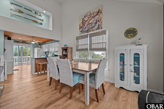 4121 W Whispering Winds Ct Lot 17, Nags Head, NC 27959 - dining room with light wood-type flooring, a towering ceiling, ceiling fan, and baseboards
