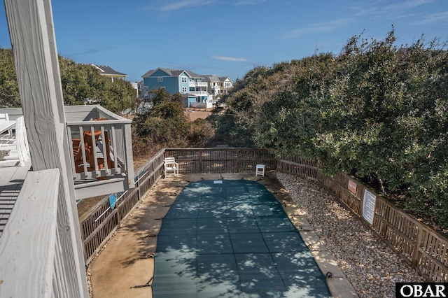 view of swimming pool featuring fence