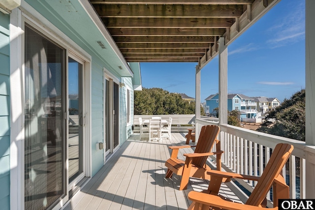 wooden deck with visible vents and a residential view