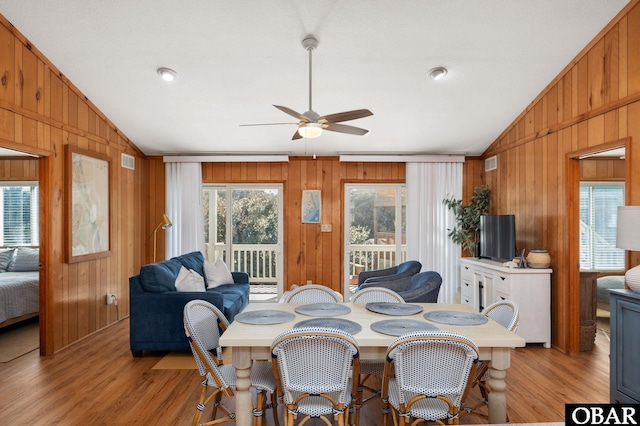 dining space with plenty of natural light, a ceiling fan, and vaulted ceiling