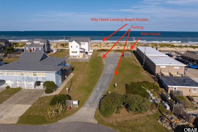 birds eye view of property featuring a residential view, a water view, and a beach view