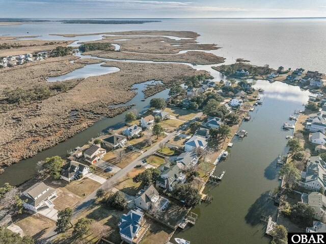 drone / aerial view with a water view and a residential view