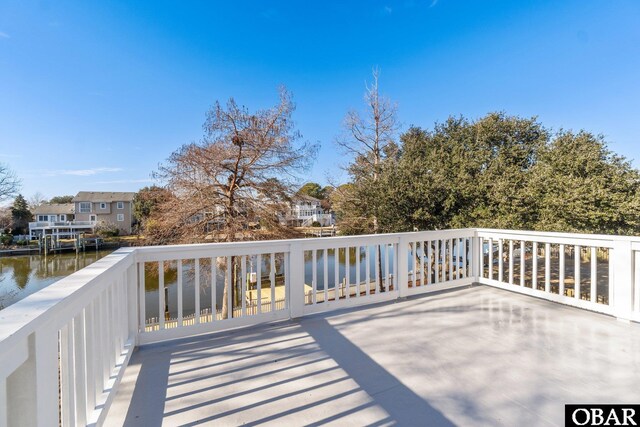 wooden terrace featuring a water view