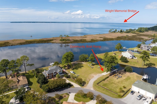 birds eye view of property with a water view and a residential view