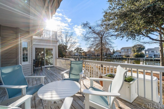 deck featuring a water view and a residential view