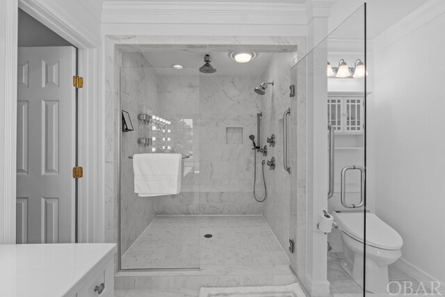 full bath featuring marble finish floor, crown molding, a shower stall, and toilet