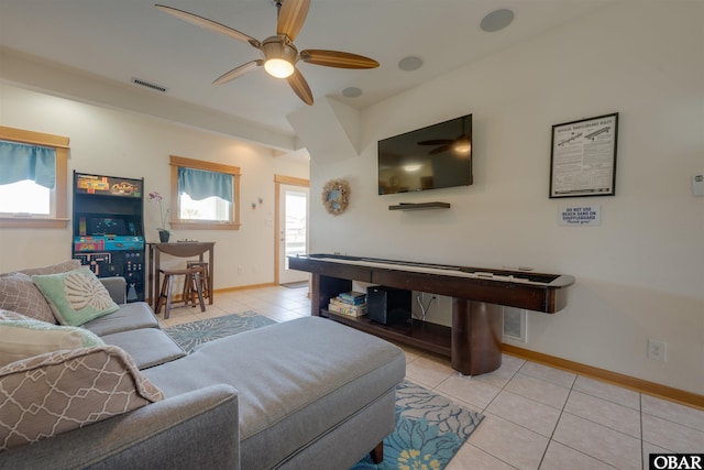 living area featuring visible vents, baseboards, ceiling fan, and tile patterned floors