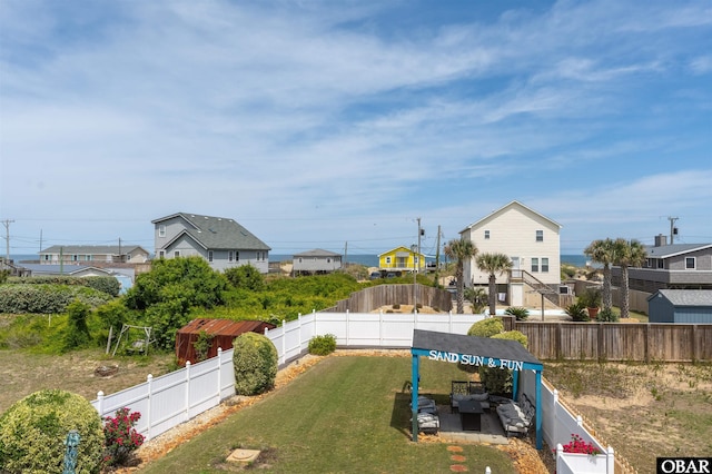 exterior space featuring an outdoor living space, a residential view, and a fenced backyard