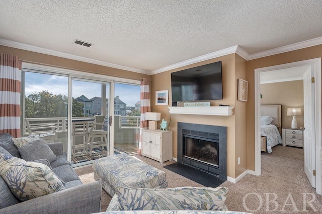 living area featuring crown molding, visible vents, a fireplace with flush hearth, carpet flooring, and baseboards