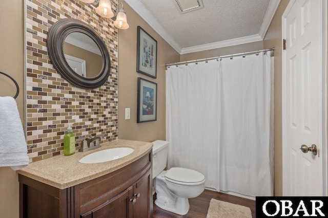 424 Pirates Way Unit 424A, Manteo, NC 27954 - bathroom featuring tasteful backsplash, visible vents, ornamental molding, a textured ceiling, and wood finished floors