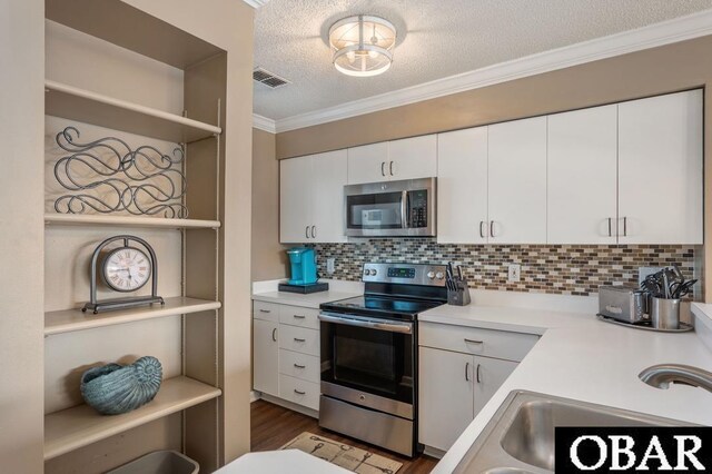424 Pirates Way Unit 424A, Manteo, NC 27954 - kitchen with visible vents, light countertops, open shelves, and stainless steel appliances