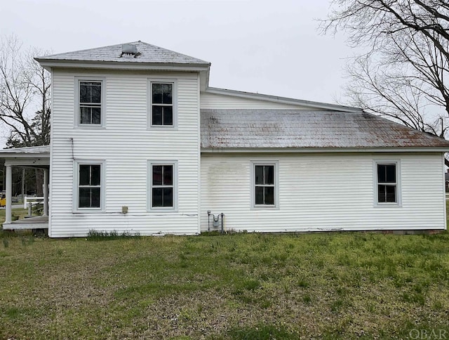 rear view of property with a yard