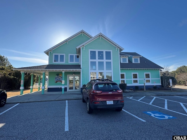 view of building exterior with uncovered parking