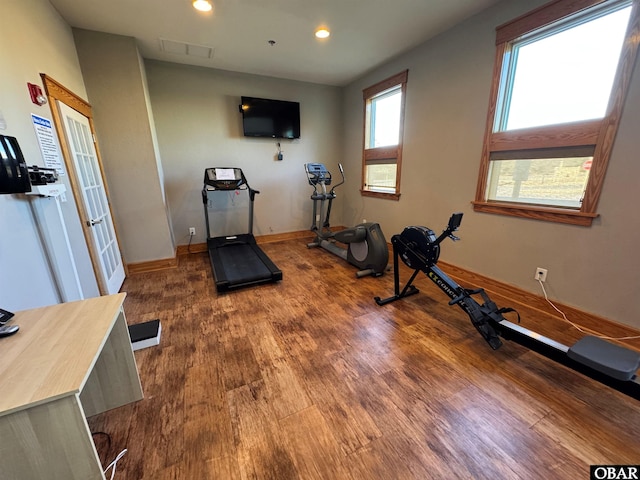 exercise room featuring visible vents, baseboards, wood finished floors, and recessed lighting