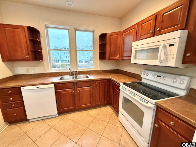 kitchen with light tile patterned floors, open shelves, dark countertops, a sink, and white appliances