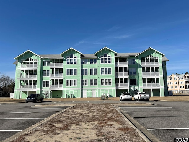 view of building exterior featuring uncovered parking