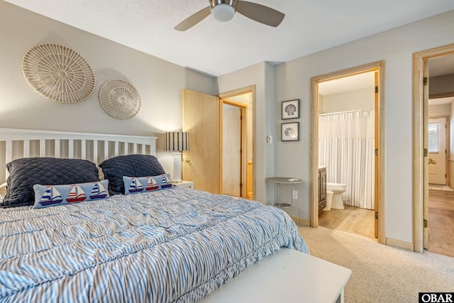 carpeted bedroom with ceiling fan, a textured ceiling, baseboards, and connected bathroom