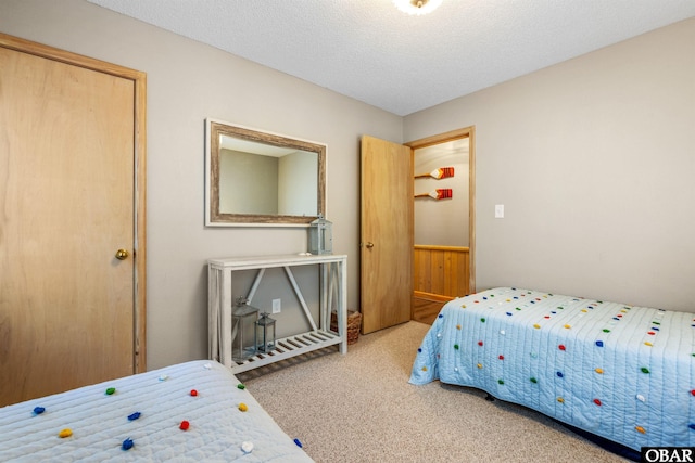 bedroom with carpet and a textured ceiling