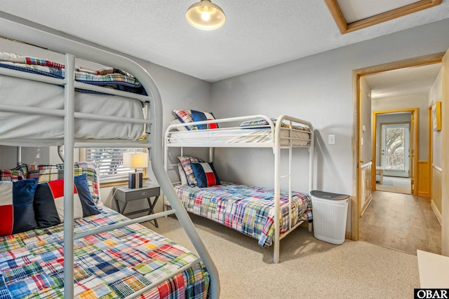 carpeted bedroom with a textured ceiling