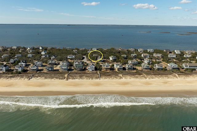 bird's eye view featuring a water view and a view of the beach