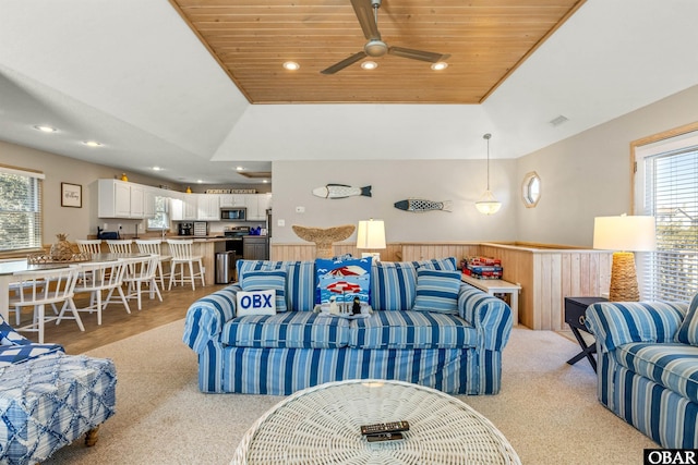 living area with light colored carpet, recessed lighting, visible vents, wood ceiling, and a raised ceiling