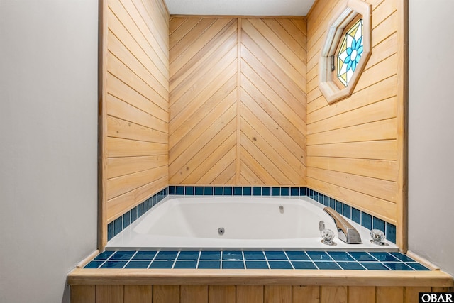 full bathroom featuring wooden walls and a tub with jets