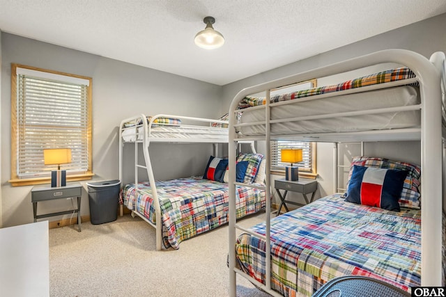 carpeted bedroom with a textured ceiling