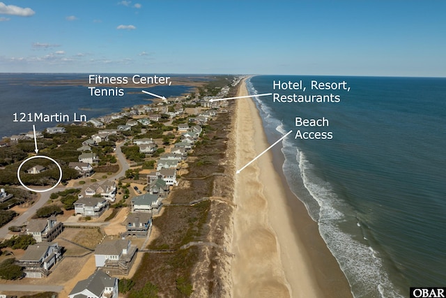 bird's eye view featuring a water view and a beach view